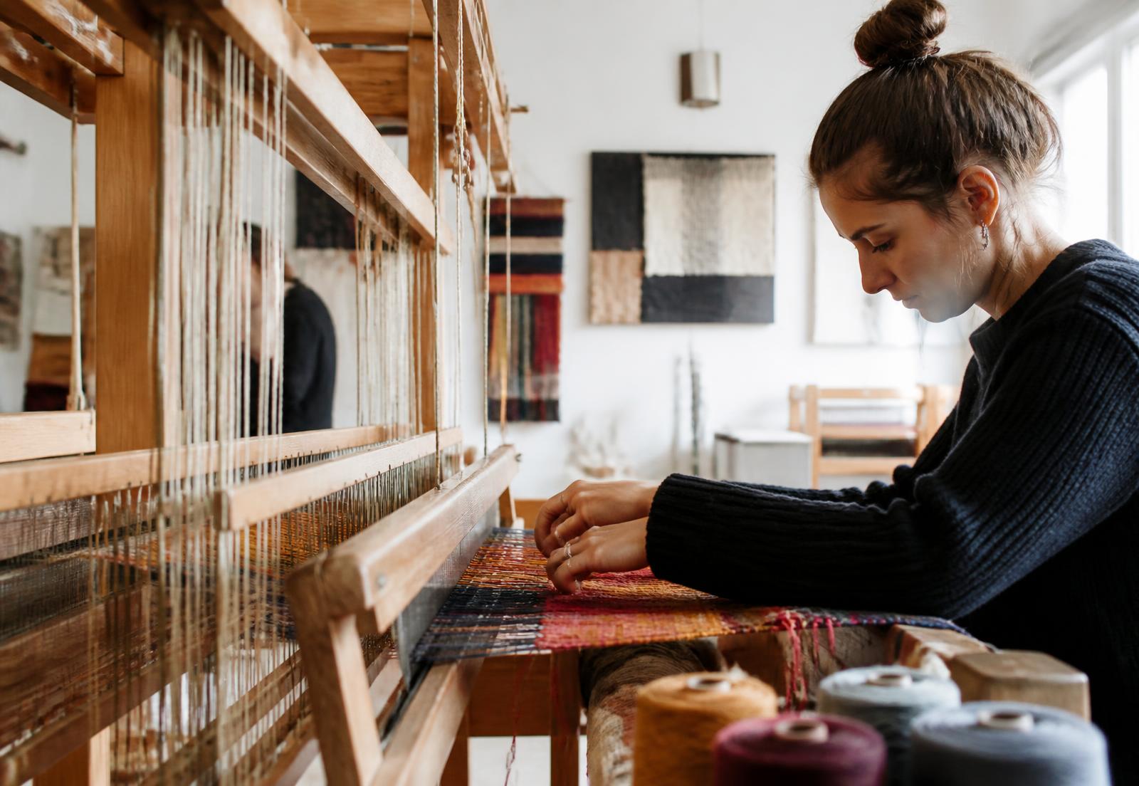Student weaving on a loom in the INU textile design studio