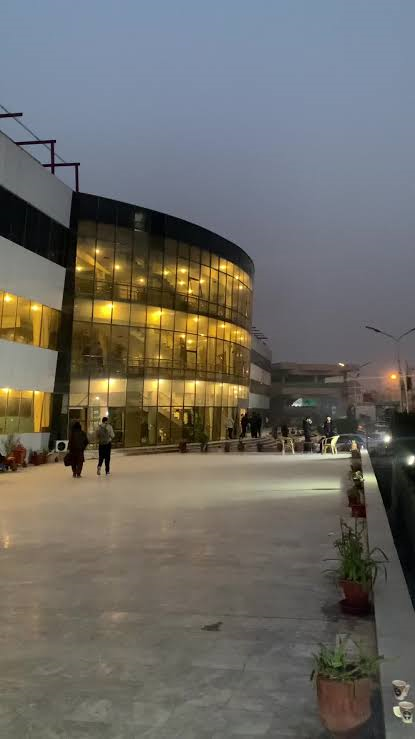 INU campus building at dusk overlooking the main plaza in Hayatabad, Peshawar