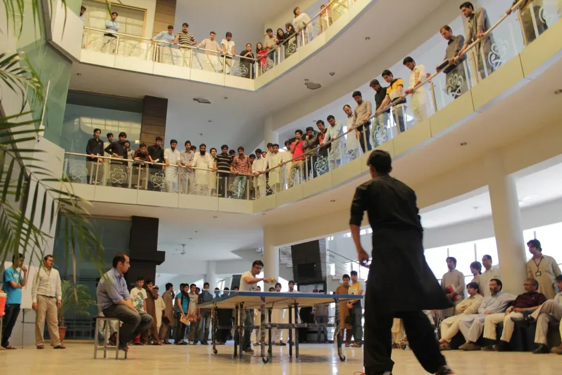 INU students playing table tennis indoors